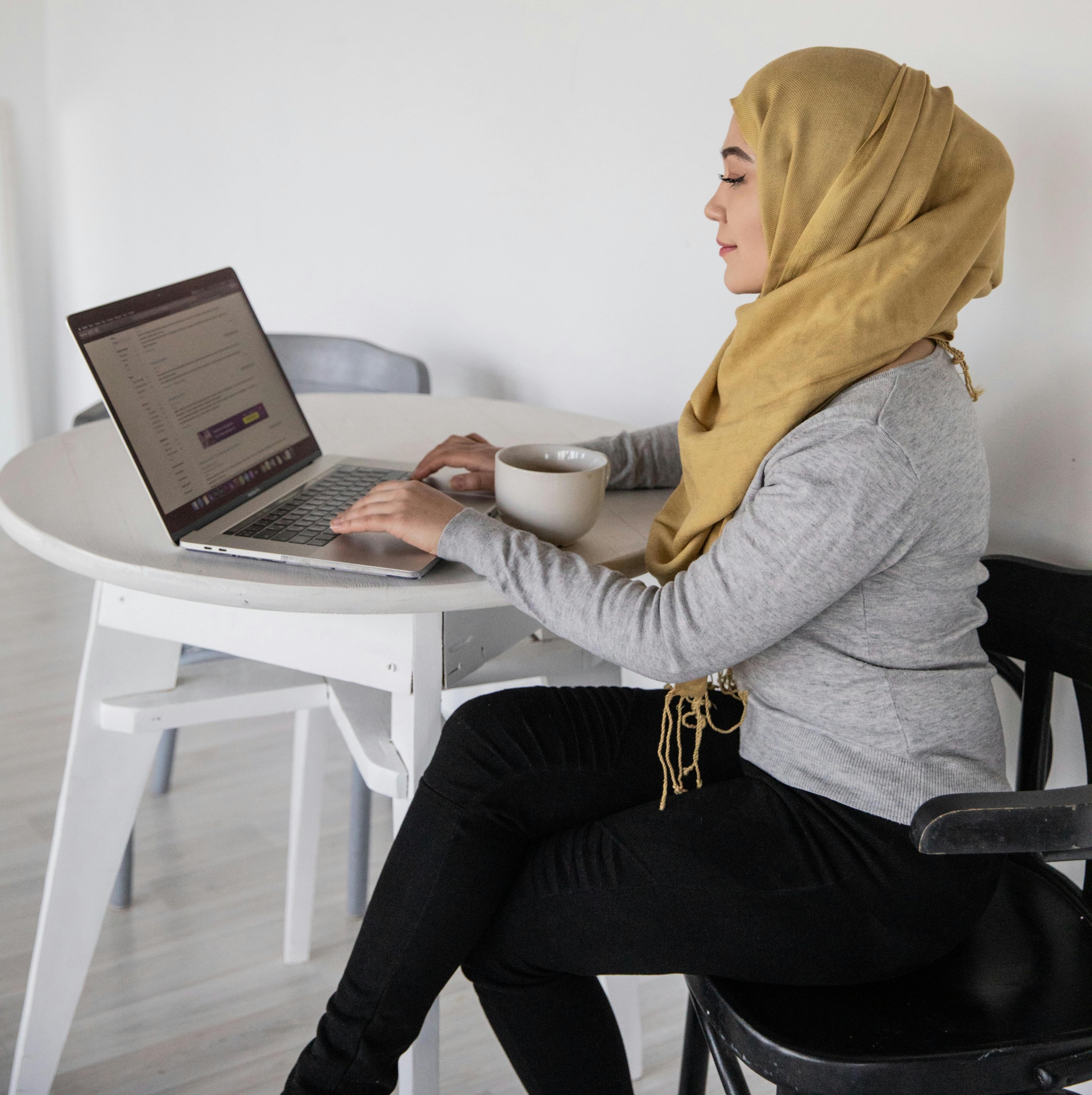 Woman in headscarf working on computer