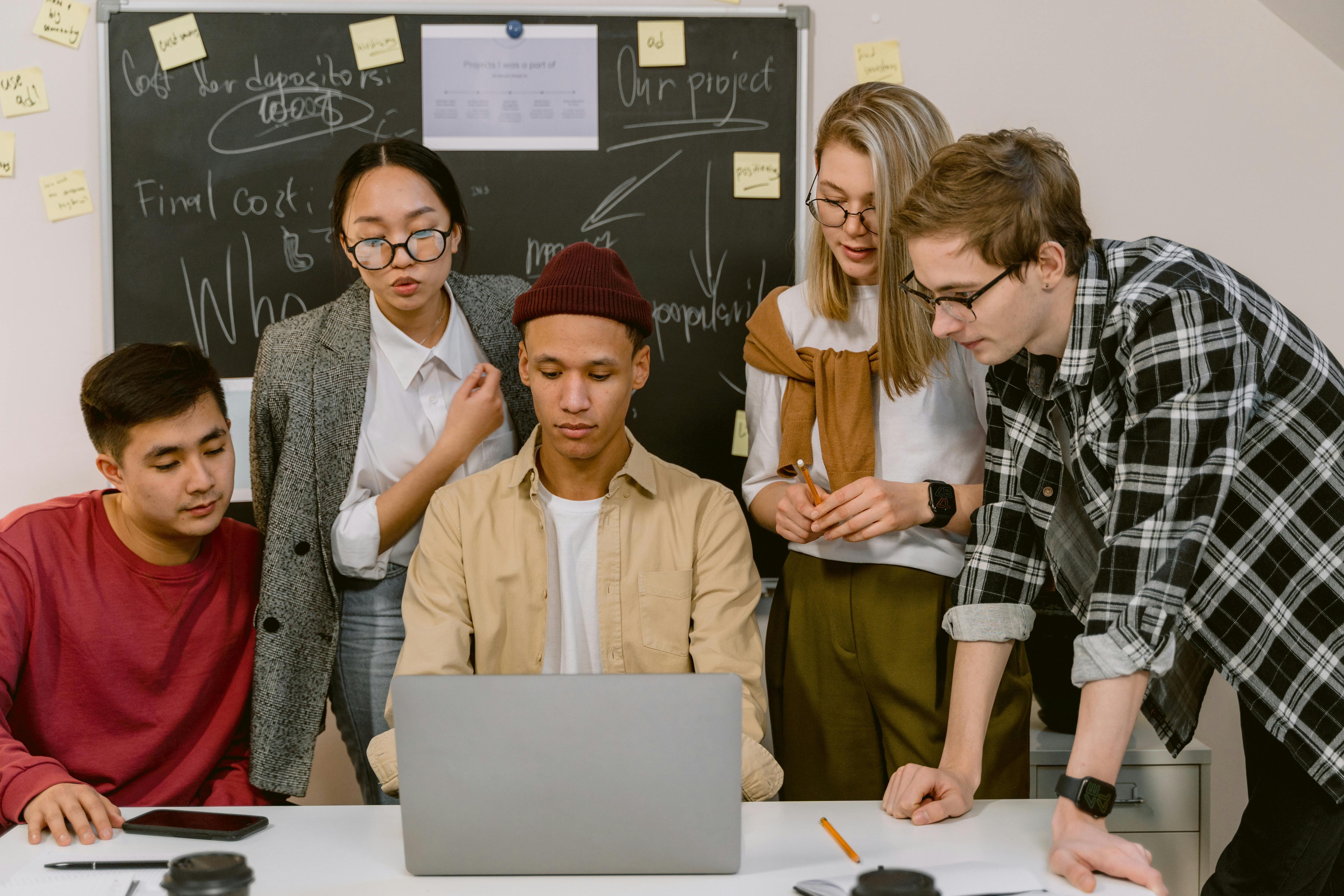 Male and female workers at laptop