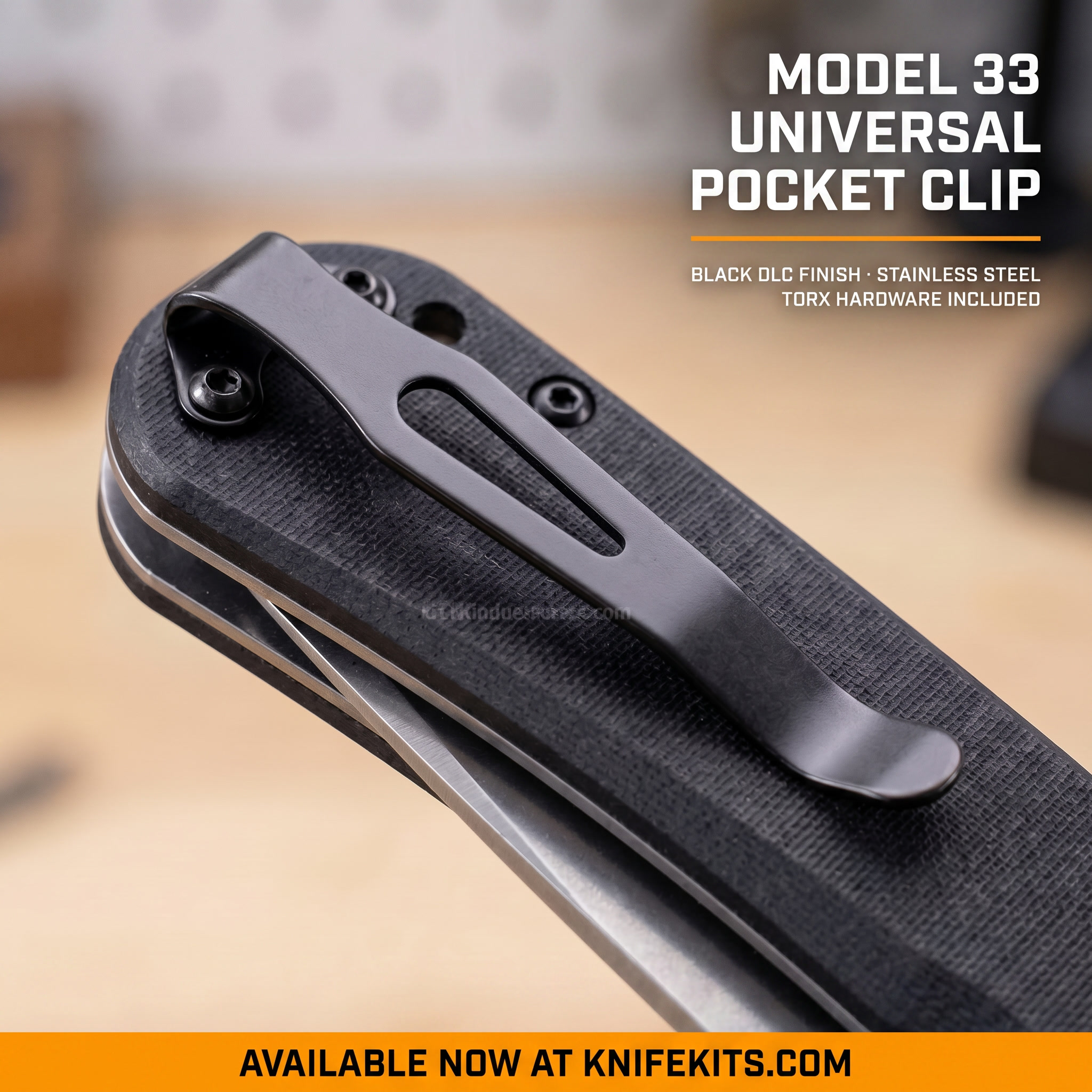 Model 33 Foldover Pocket Clip in Black DLC Finish — stainless steel clip with two included 2-56 TORX mounting screws, shown against a light wood background. Available at KnifeKits.com.