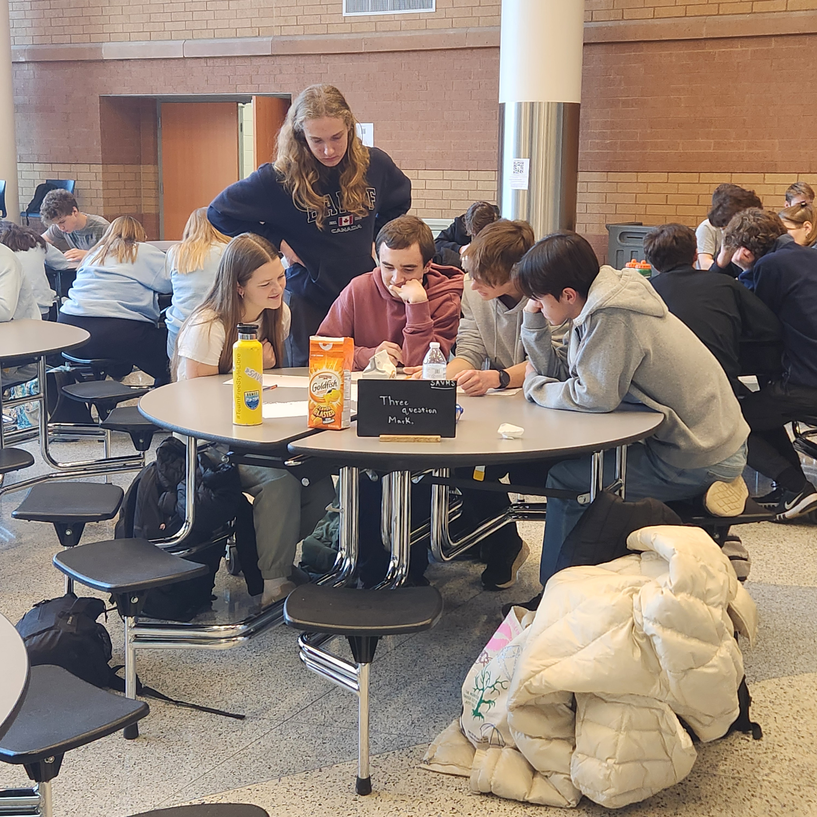Knowledge Bowl students sit at a table together.