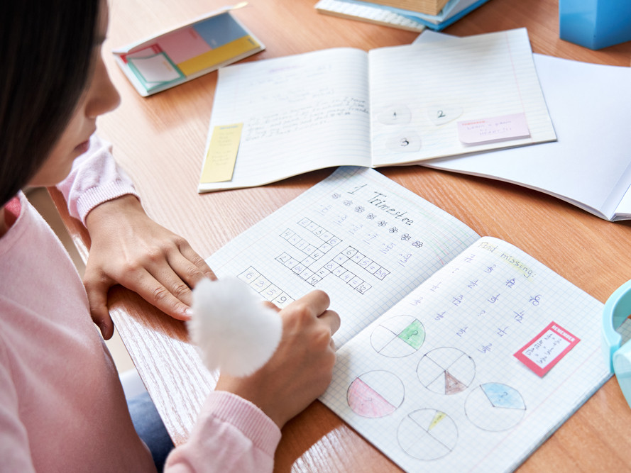 Student working in a math workbook.