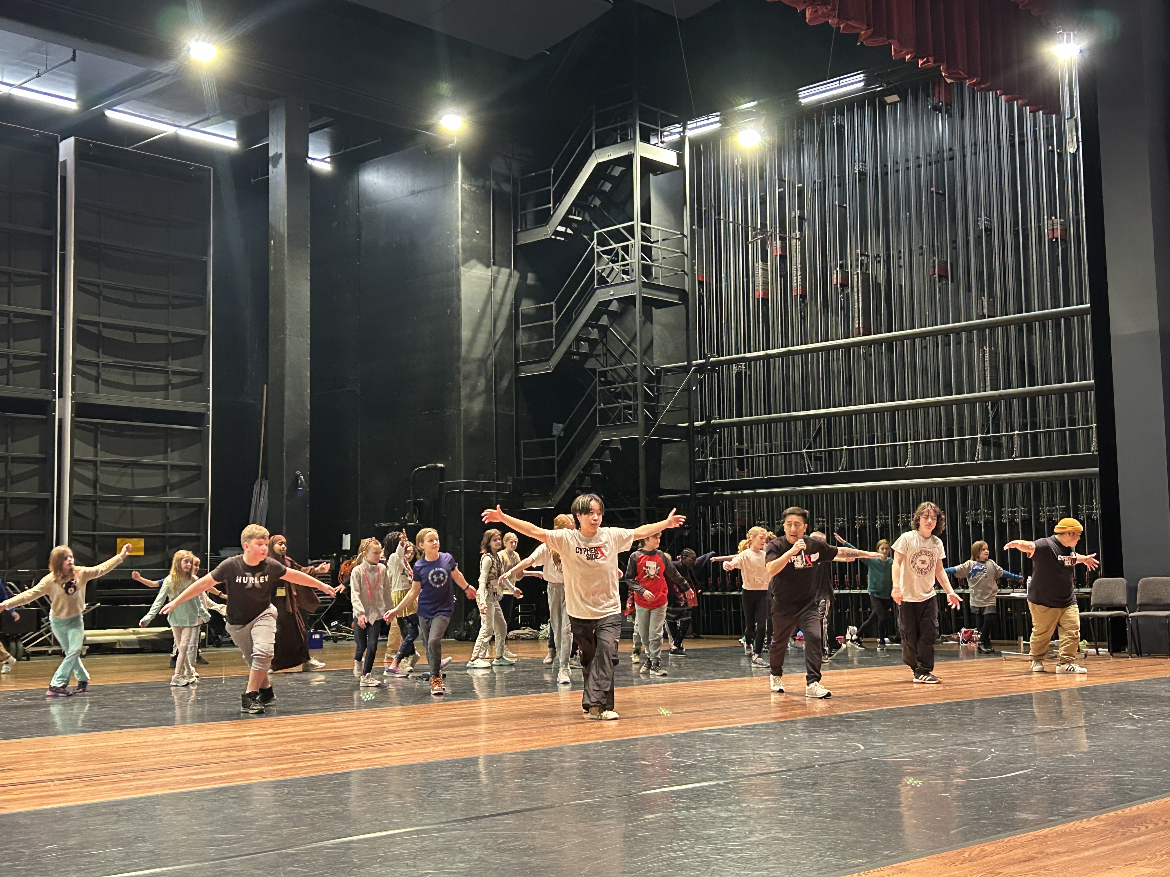 Students learn to breakdance on the Ted Mann Concert Hall stage.