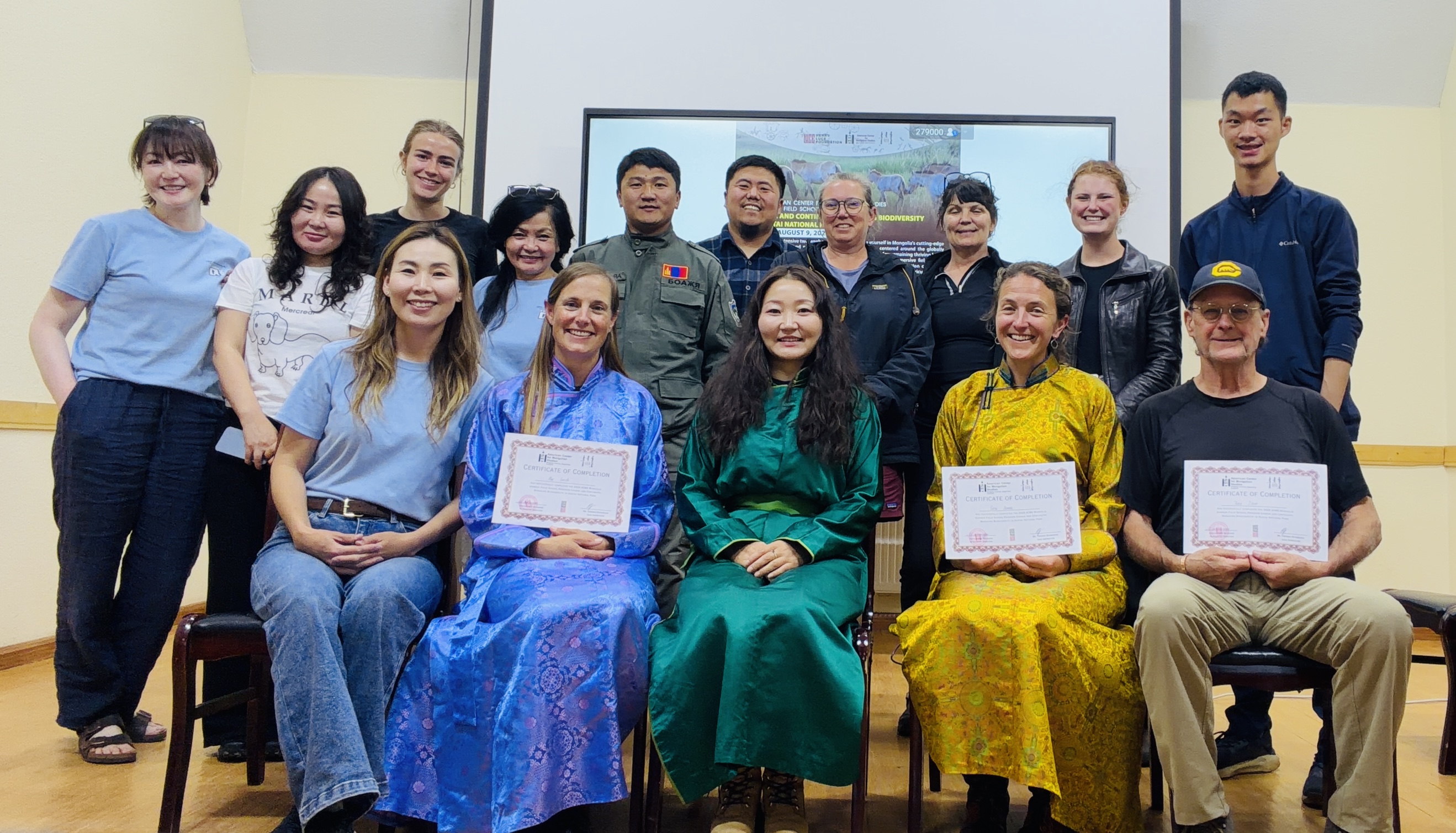 A group of American and Mongolian adults posing together and smiling for the camera.