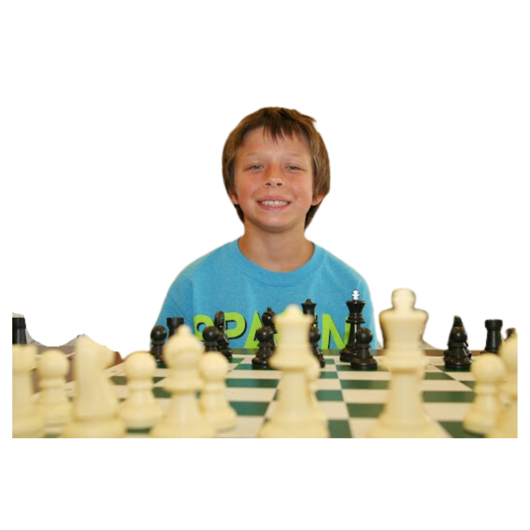 Boy smiling over chess pieces