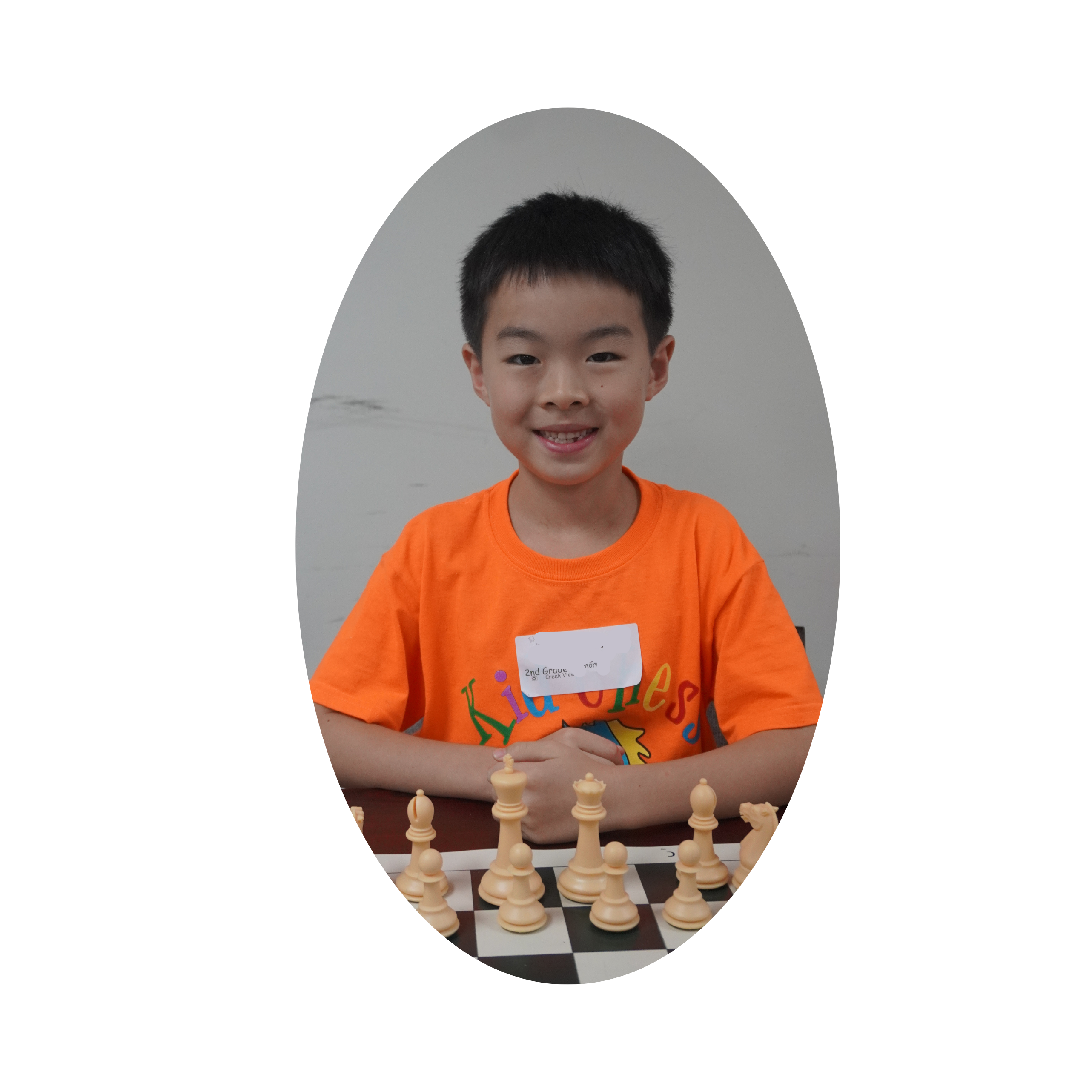 boy smiling at chess pieces