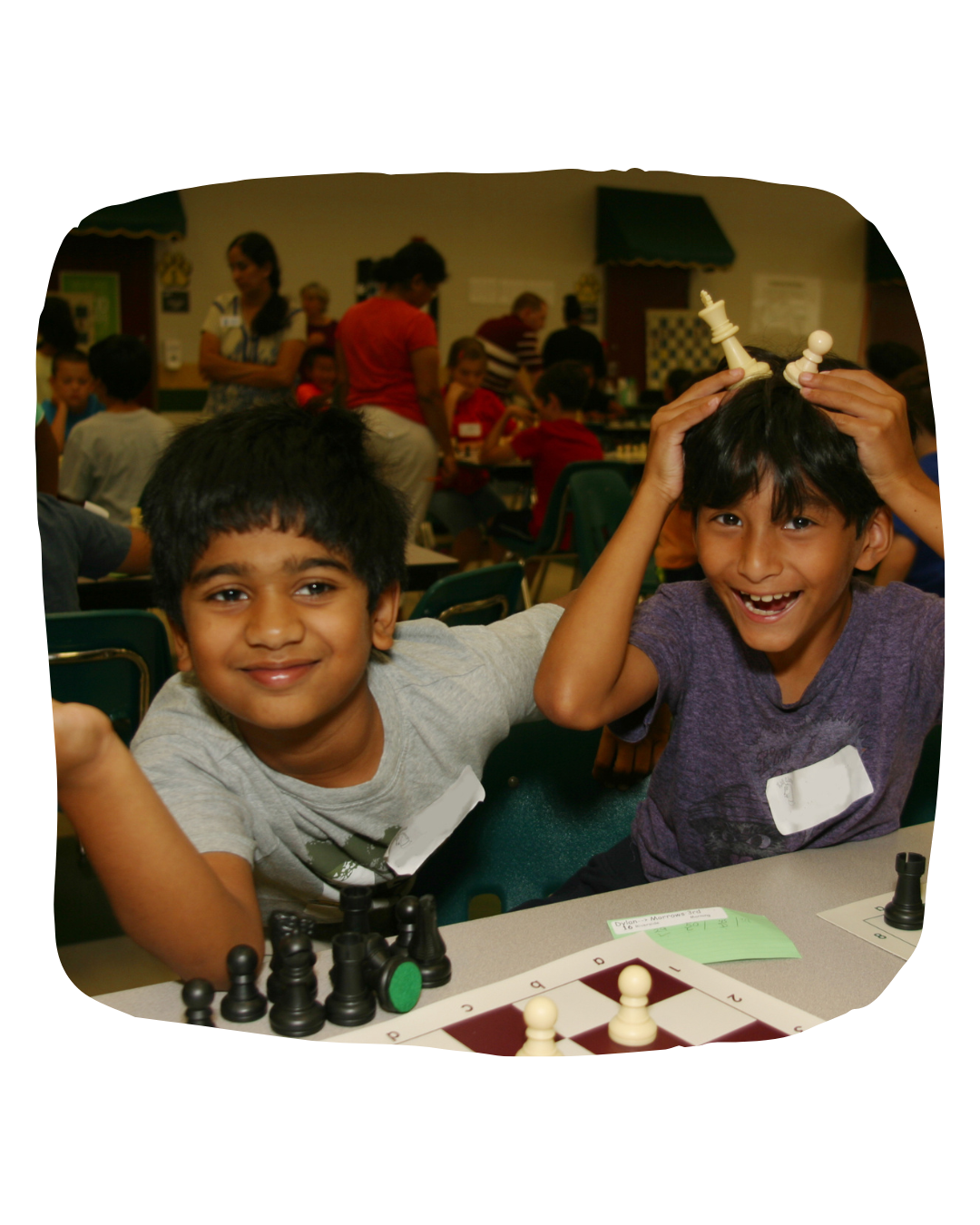 happy kids playing with chess pieces