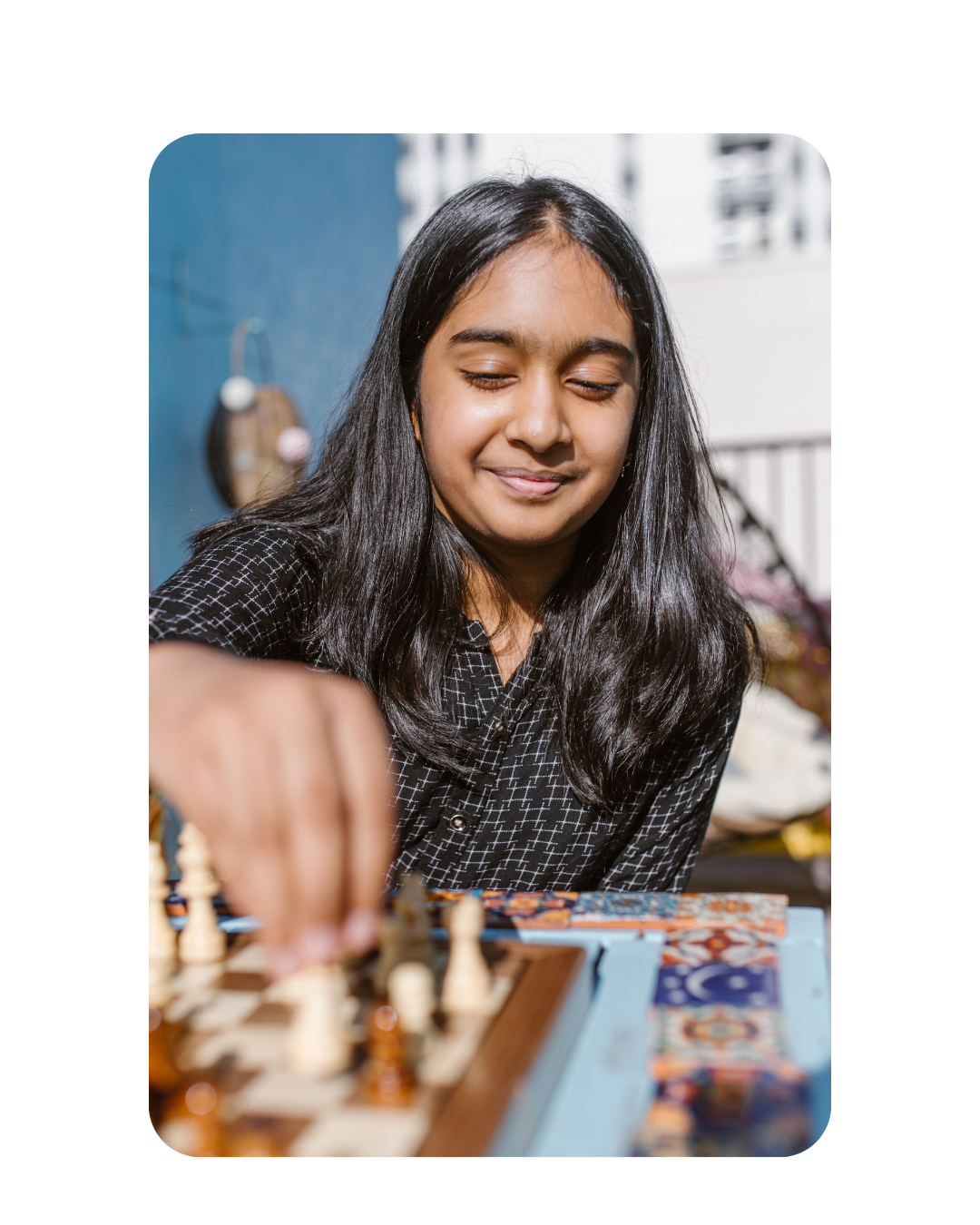 Girl smiling and playing chess