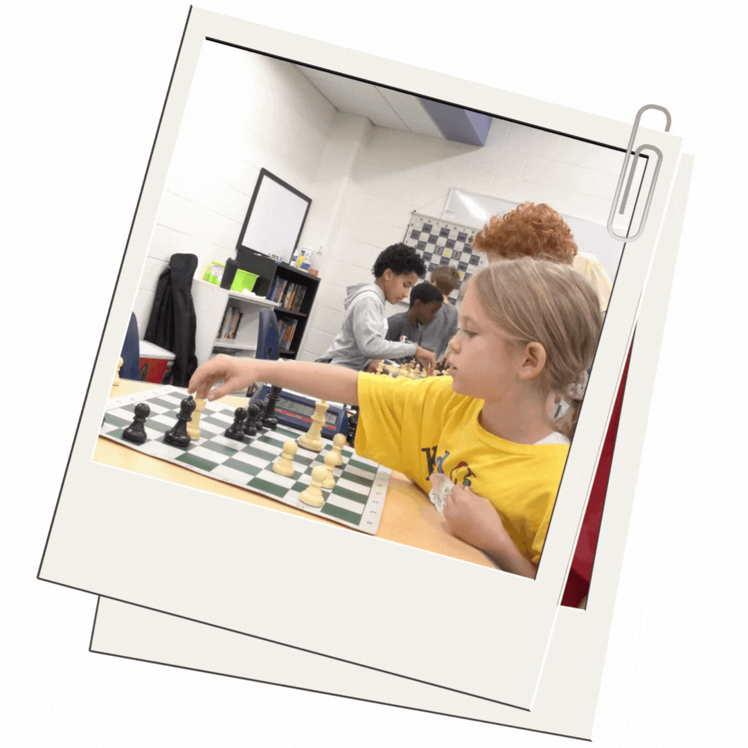 Girl smiling and playing chess
