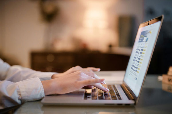 Photo of female hands working on a laptop and EP publication scedule