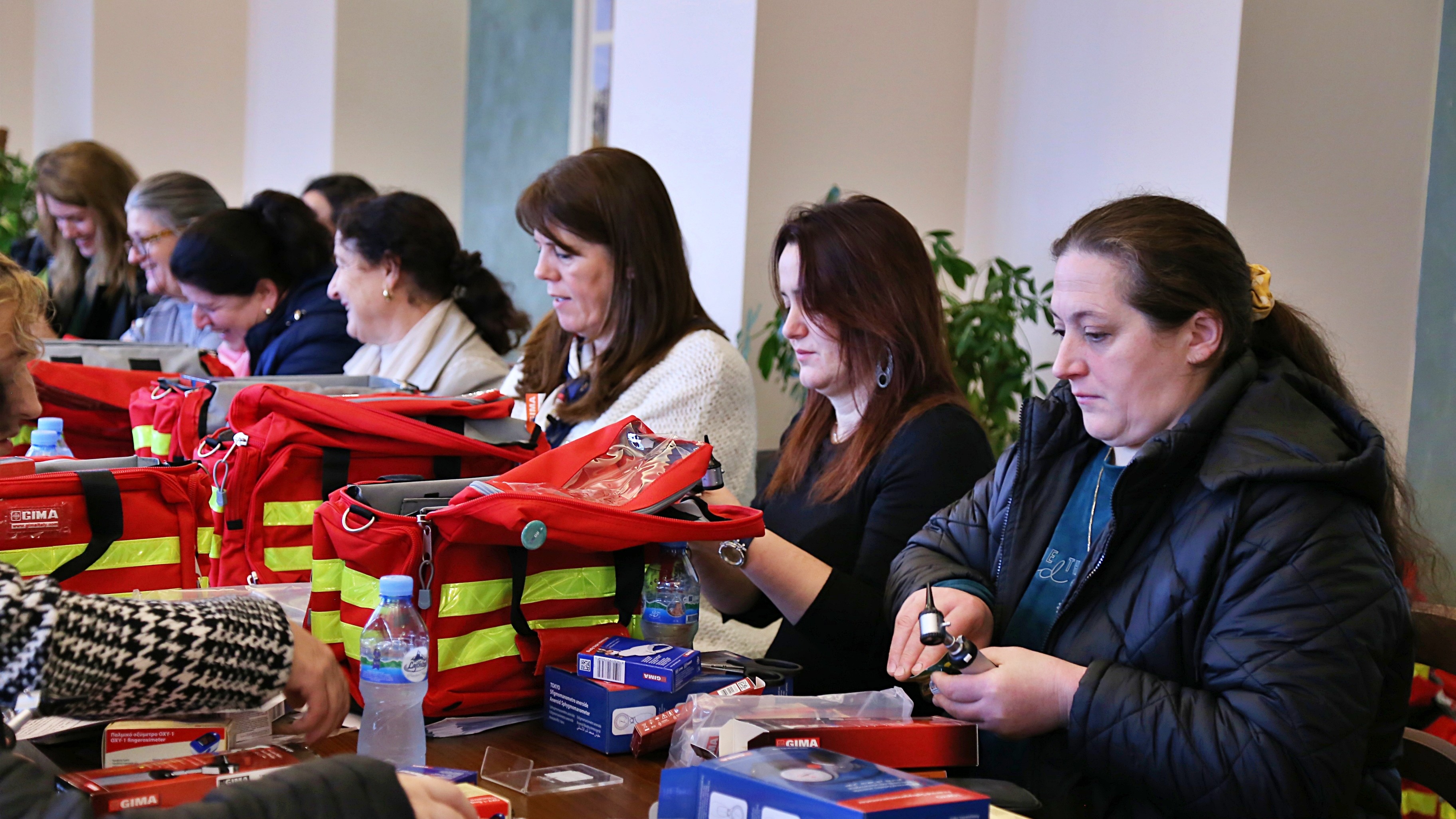 Health personnel receiving medical bags