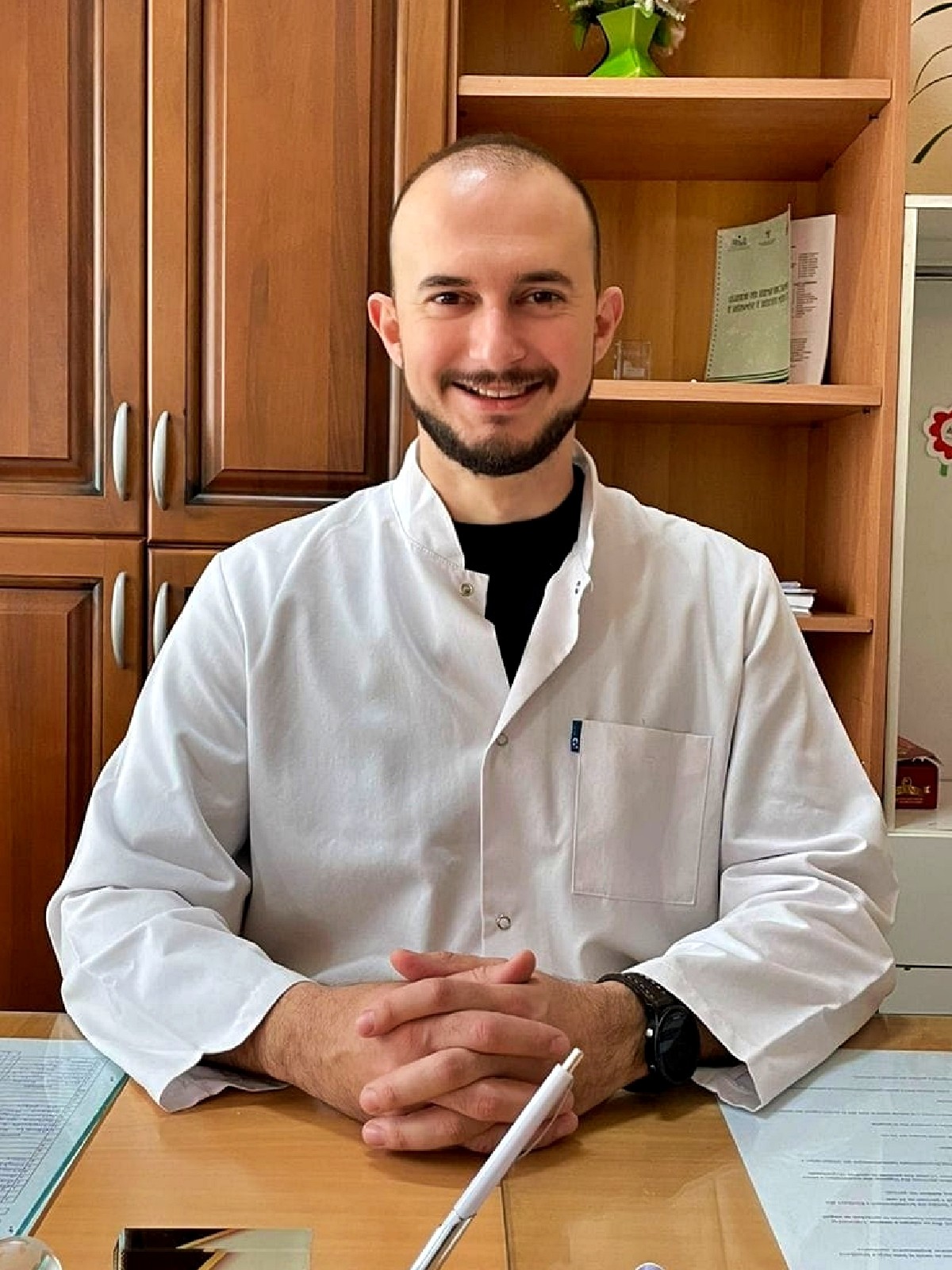 Dr. Krist Kola