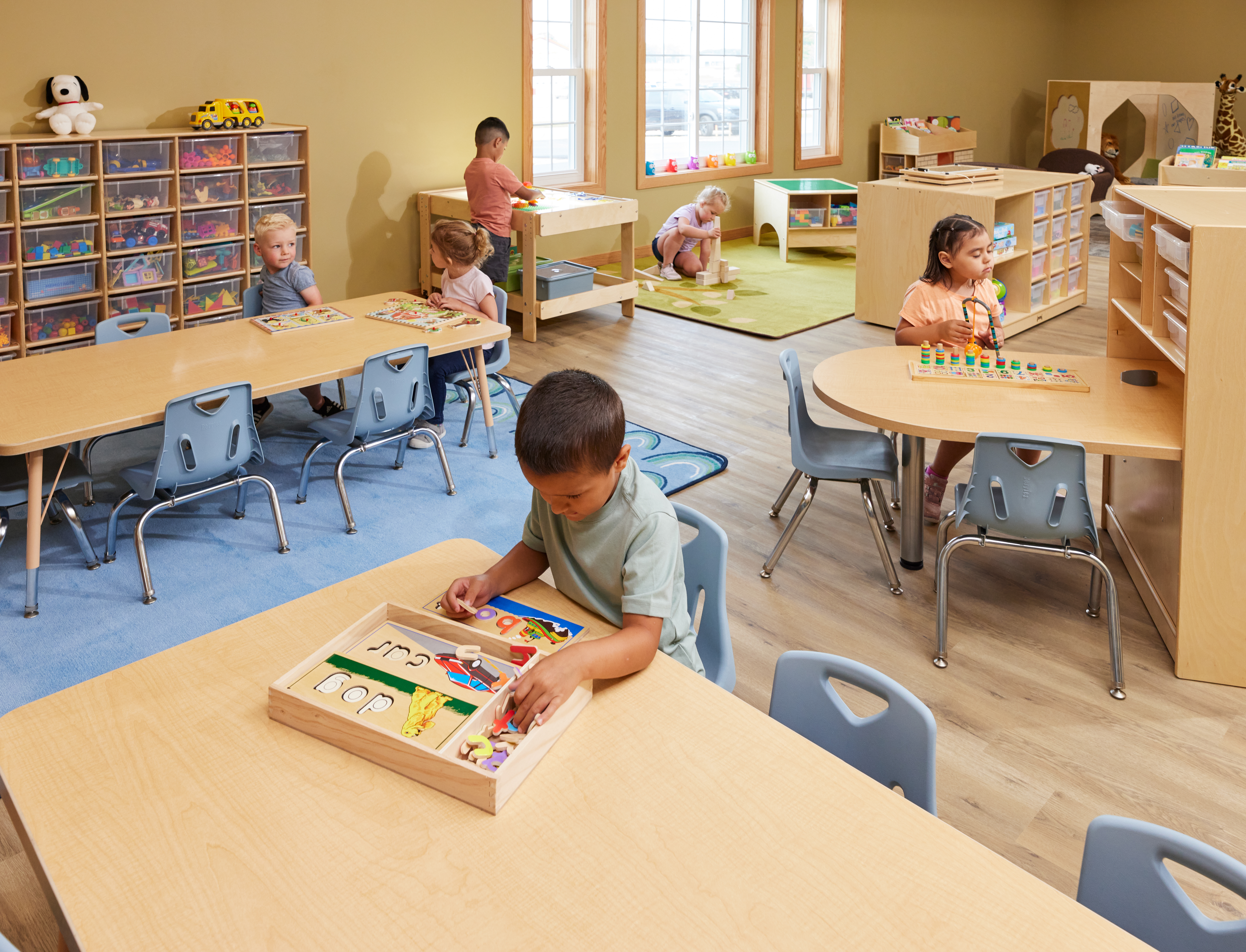 Children learning in a classroom filled with Jonti Craft products.