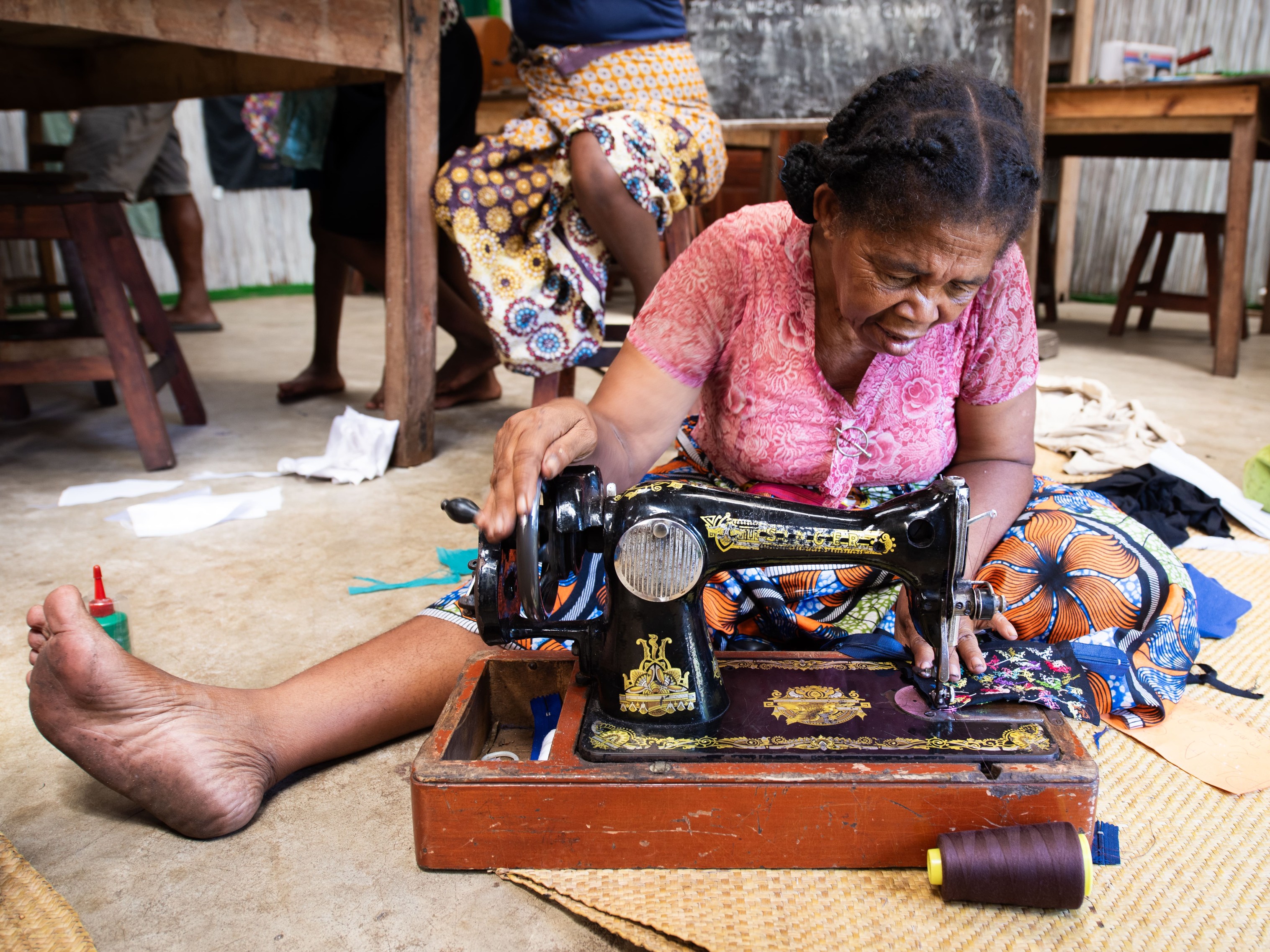 A woman in southeast Madagascar using a sewing machine to make a handmade textile as part of the Stitch initiative inspired by Sainte Luce.