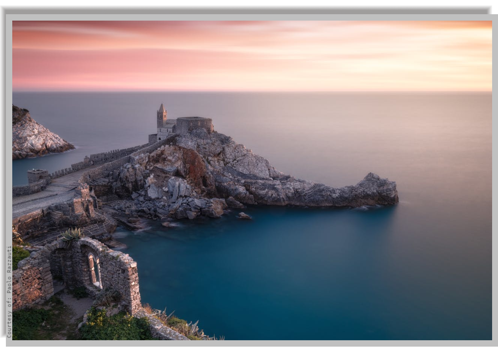 Stunnig view of Saint Peter Church on a rocky promontory on the sea. In the background suggestive view of the open sea at sunset