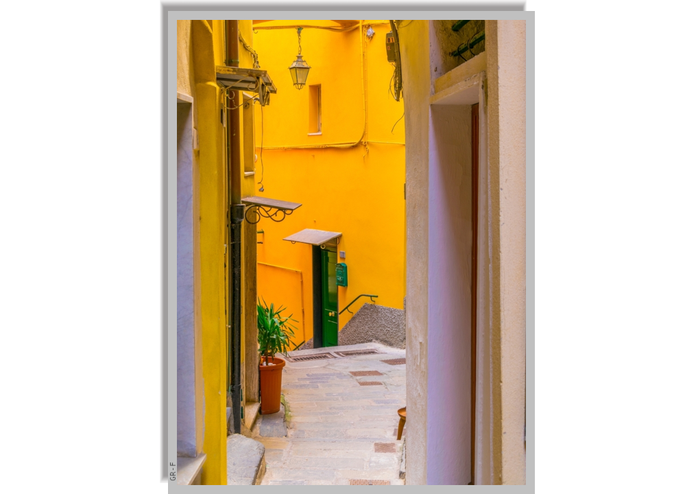 A narrow alley between colorful houses