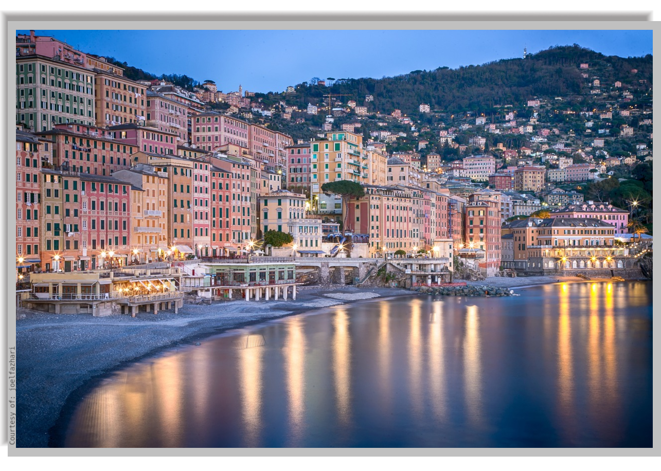 Camogli coastline in the evening, with lights reflected on the calm waters of the bay