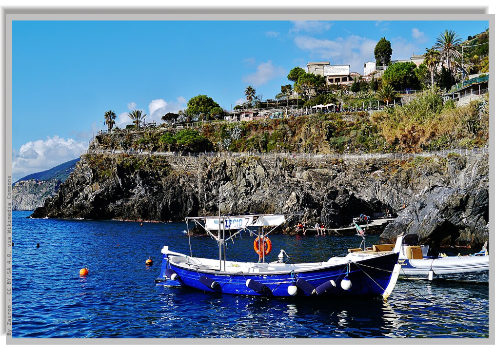 A Picturesque boat floating moored near the coast in a sunny day