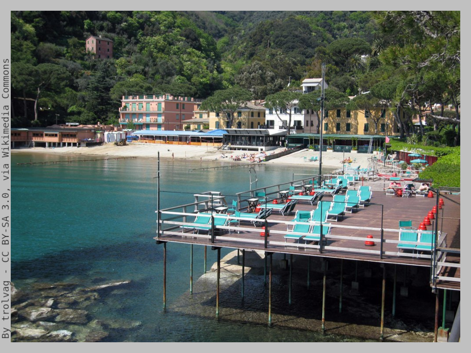 Deck over the sea with beach chairs, in front of the shore