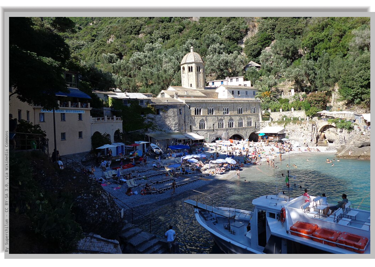 San Fruttuoso ancient Abbay and tourist boat moored to the seashore