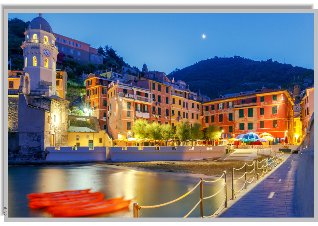 The village of Vernazza illuminated at night, seen from the pier