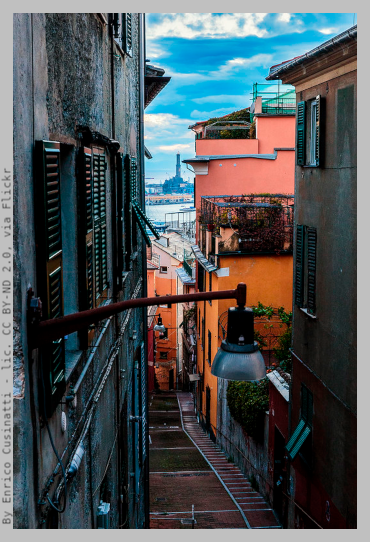 Glimpse of the Lanterna lighthouse viewed trough typical "caruggi" allays