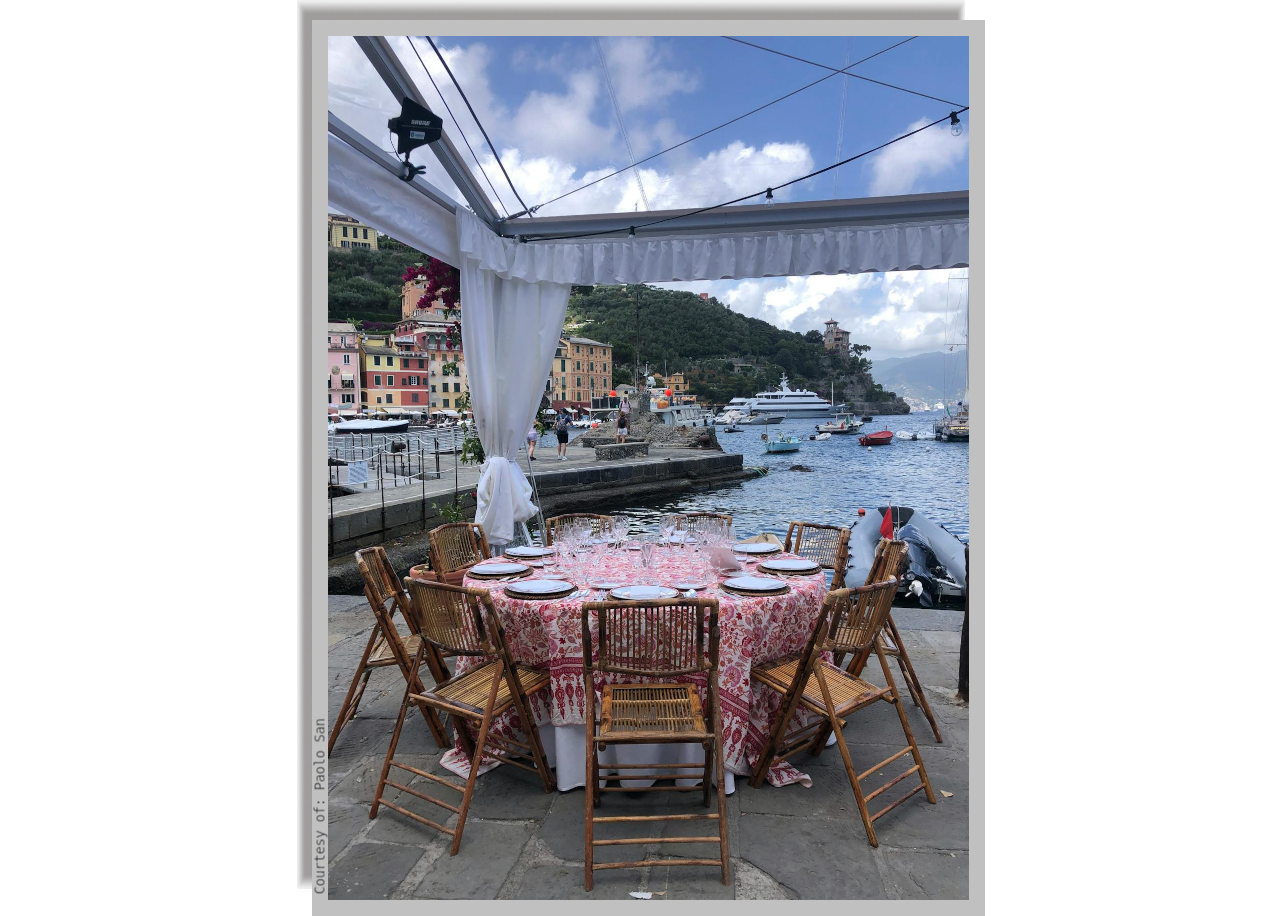 Table set up in the outdoor area of a restaurant by the marina