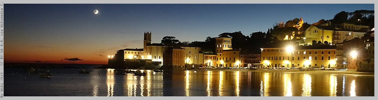 Suggestive view of Bay of Silence at sunset, with lights on the seahore