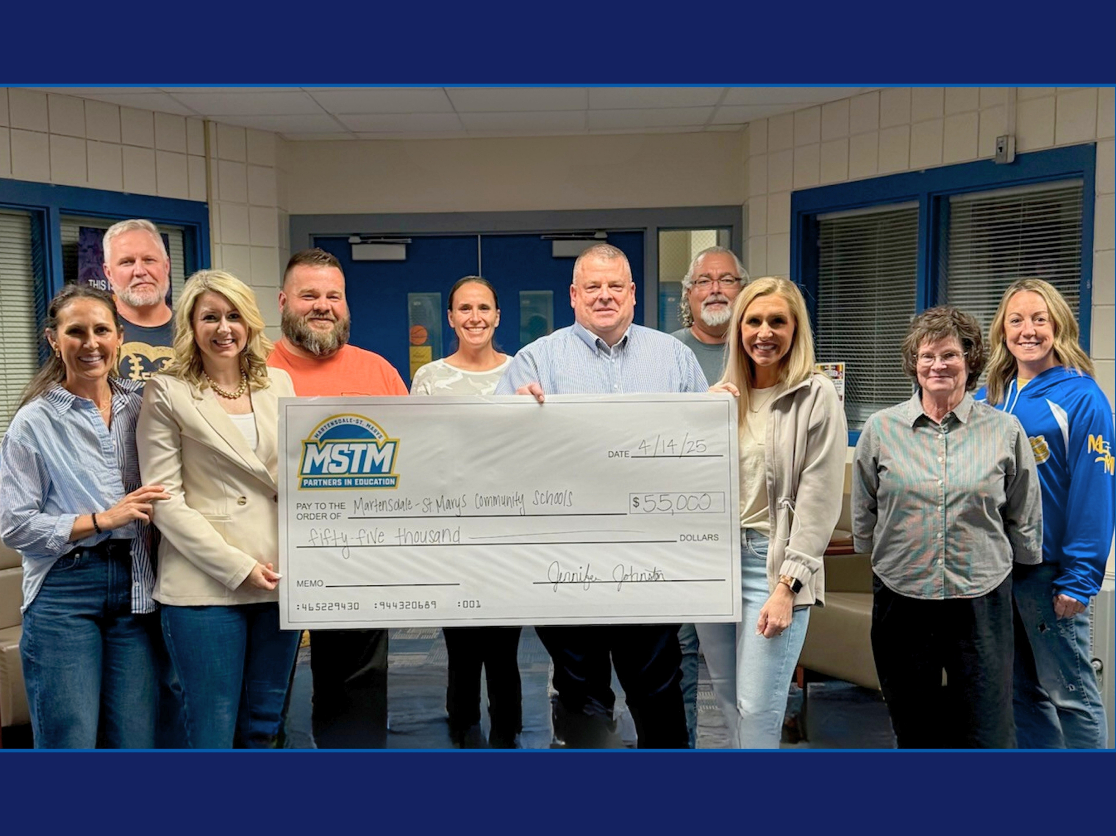 Giant check photo for the media center renovation donation