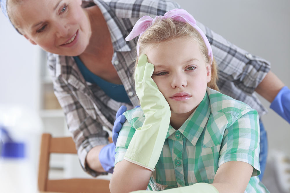 Mom talking to girl tired of cleaning