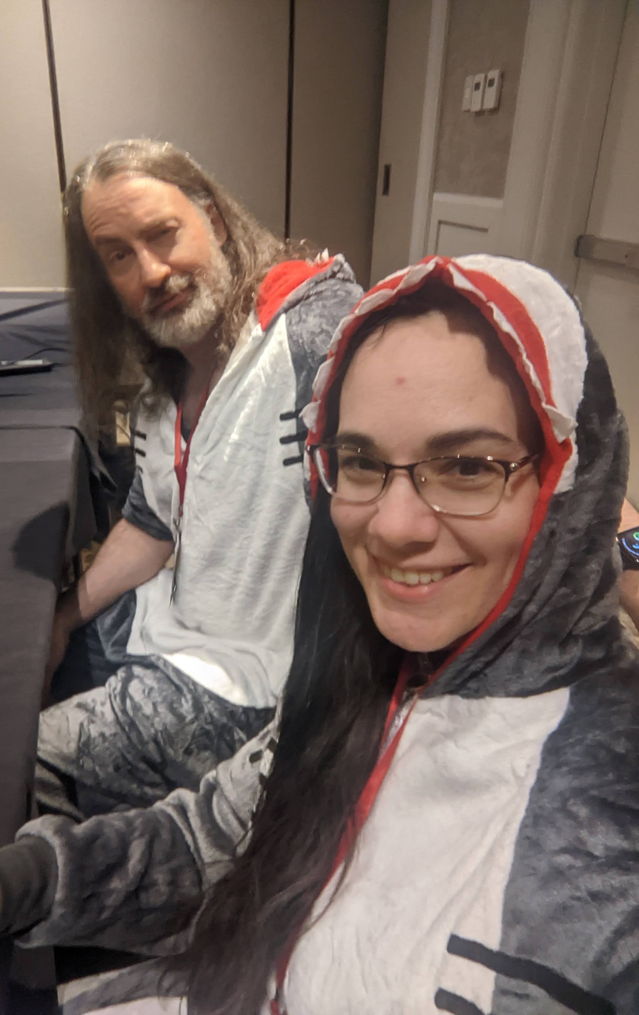 Jim and his odd little wife wearing shark costume/jammies while giving a panel on shark movies.