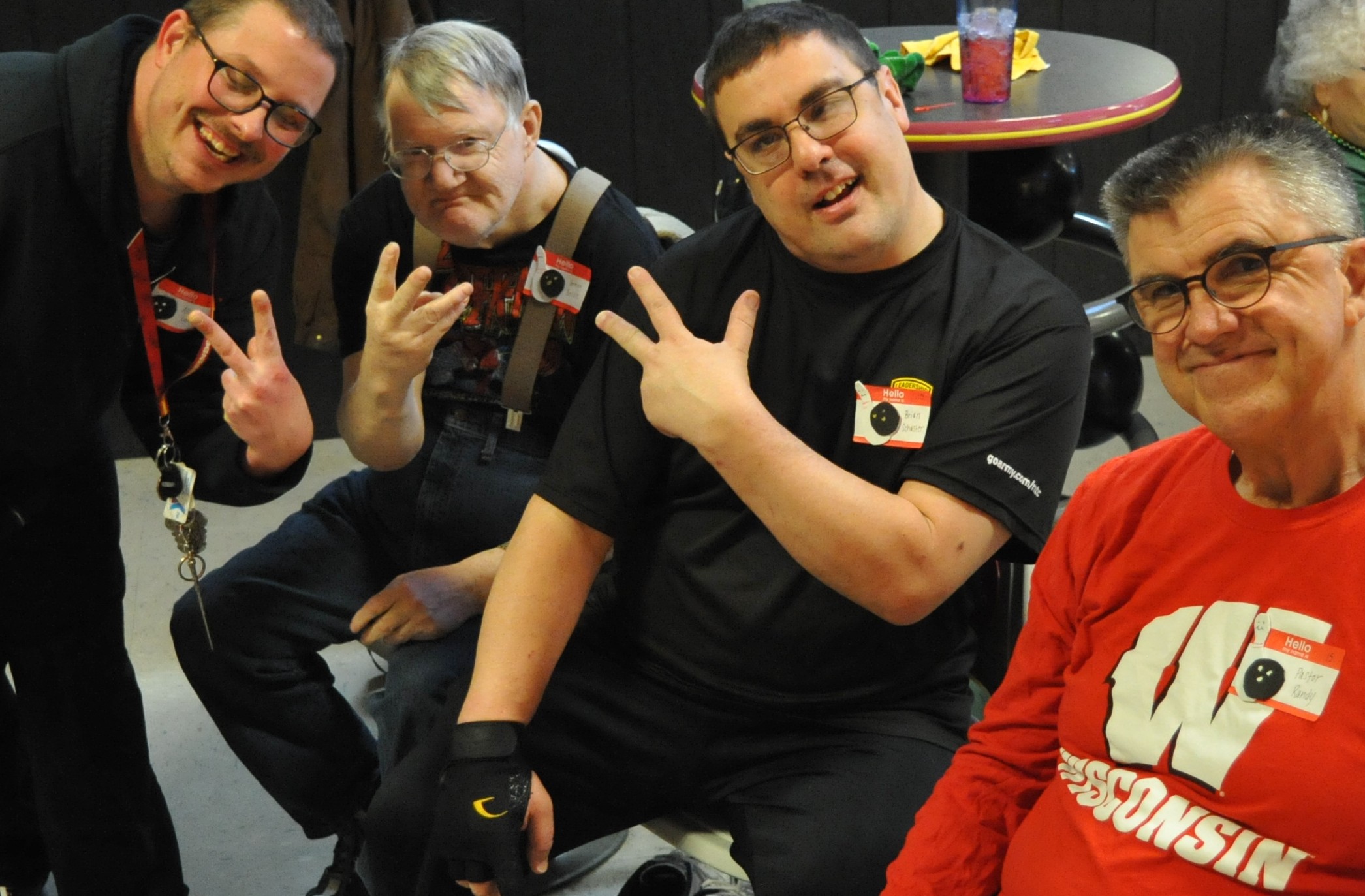 A group of guys laughing and trying to make a fun v-pose for the camera 