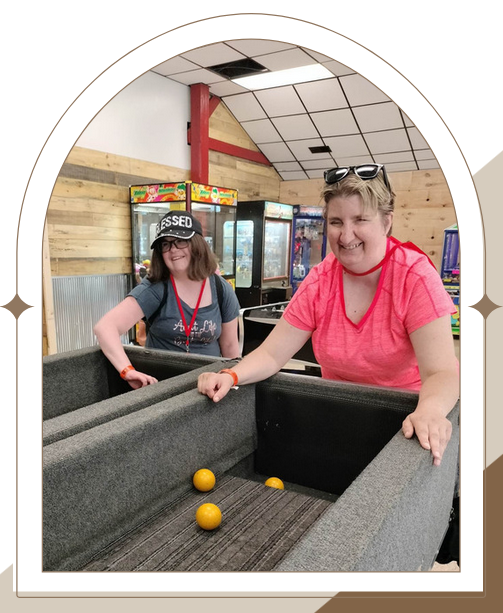 Two women playing games in a rec room