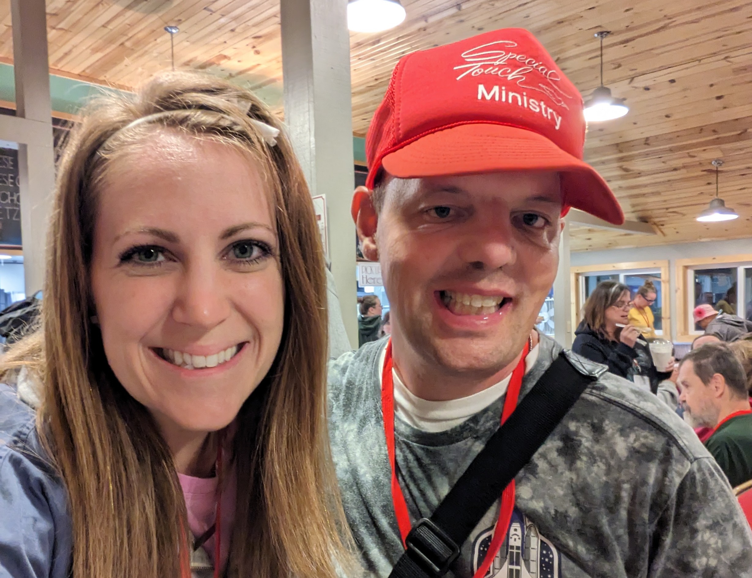 man wearing special touch hat and woman smiling