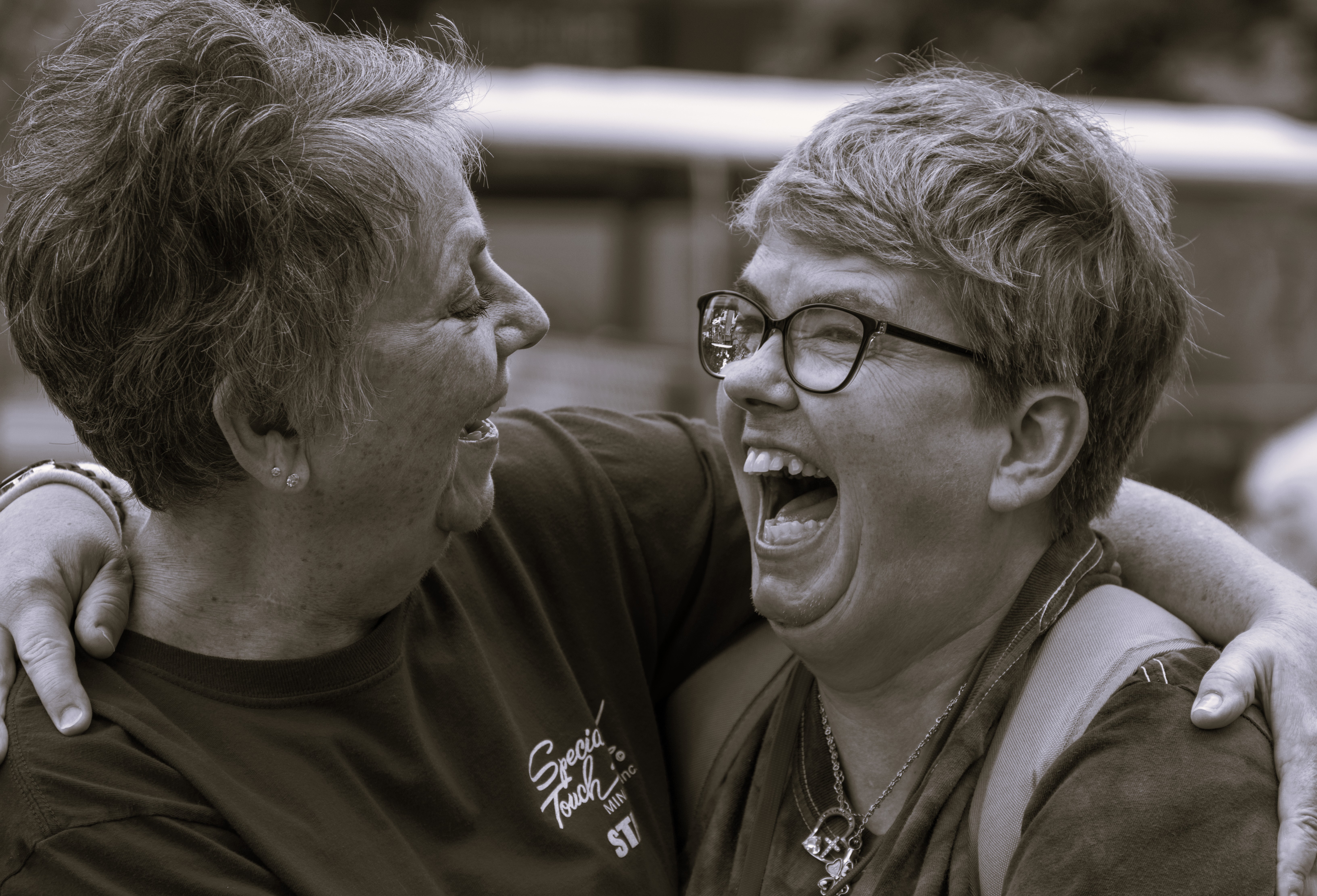 Executive director Debbie laughing with another woman 