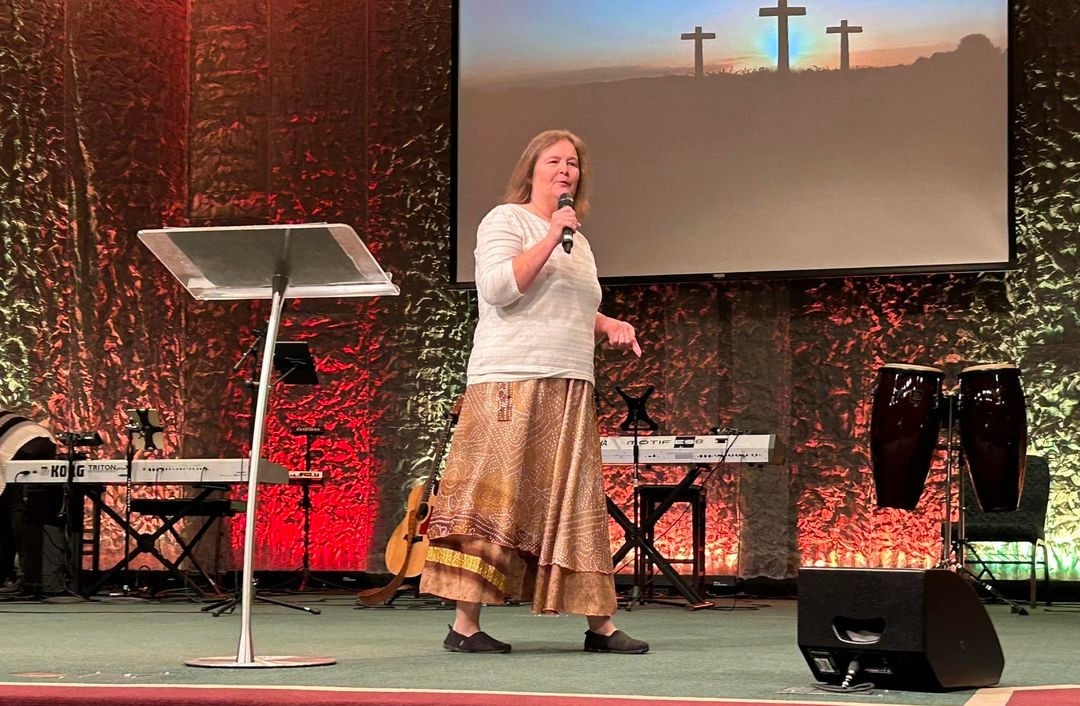 Missionary Charlene in from of a church speaking