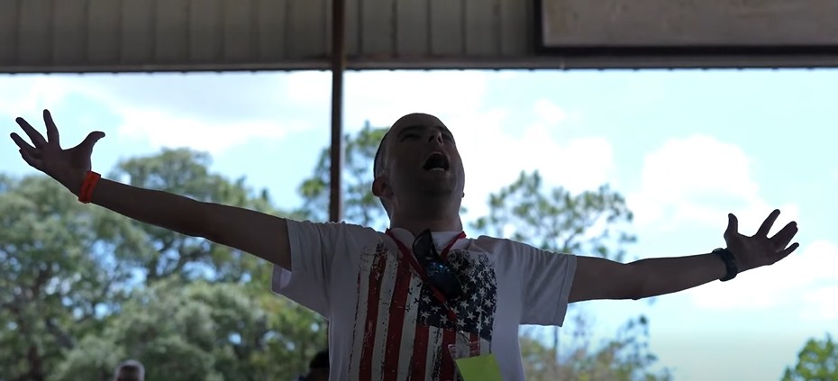 man with his arms raised looking up