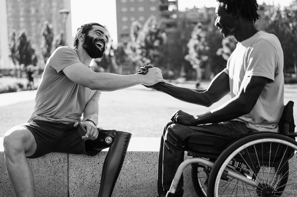 Two people with disabilities shaking hands