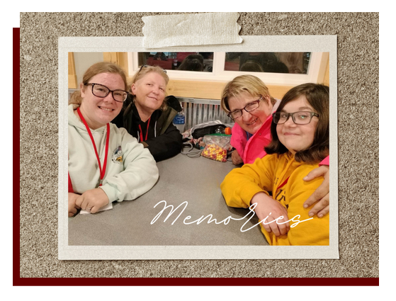 4 women sitting around a table smiling during Summer Get Away camp