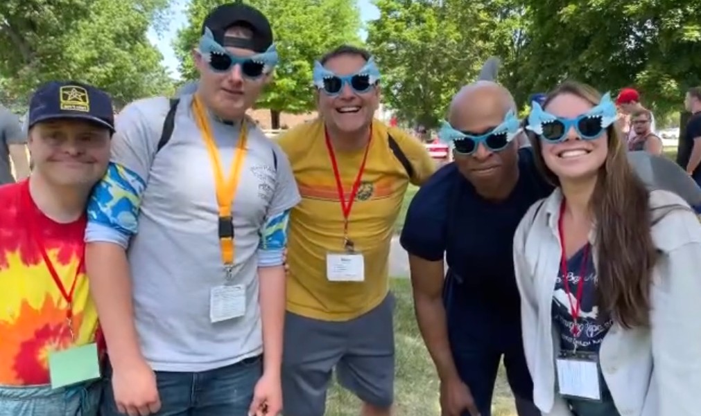 A group of staff and guests some wearing fun glasses