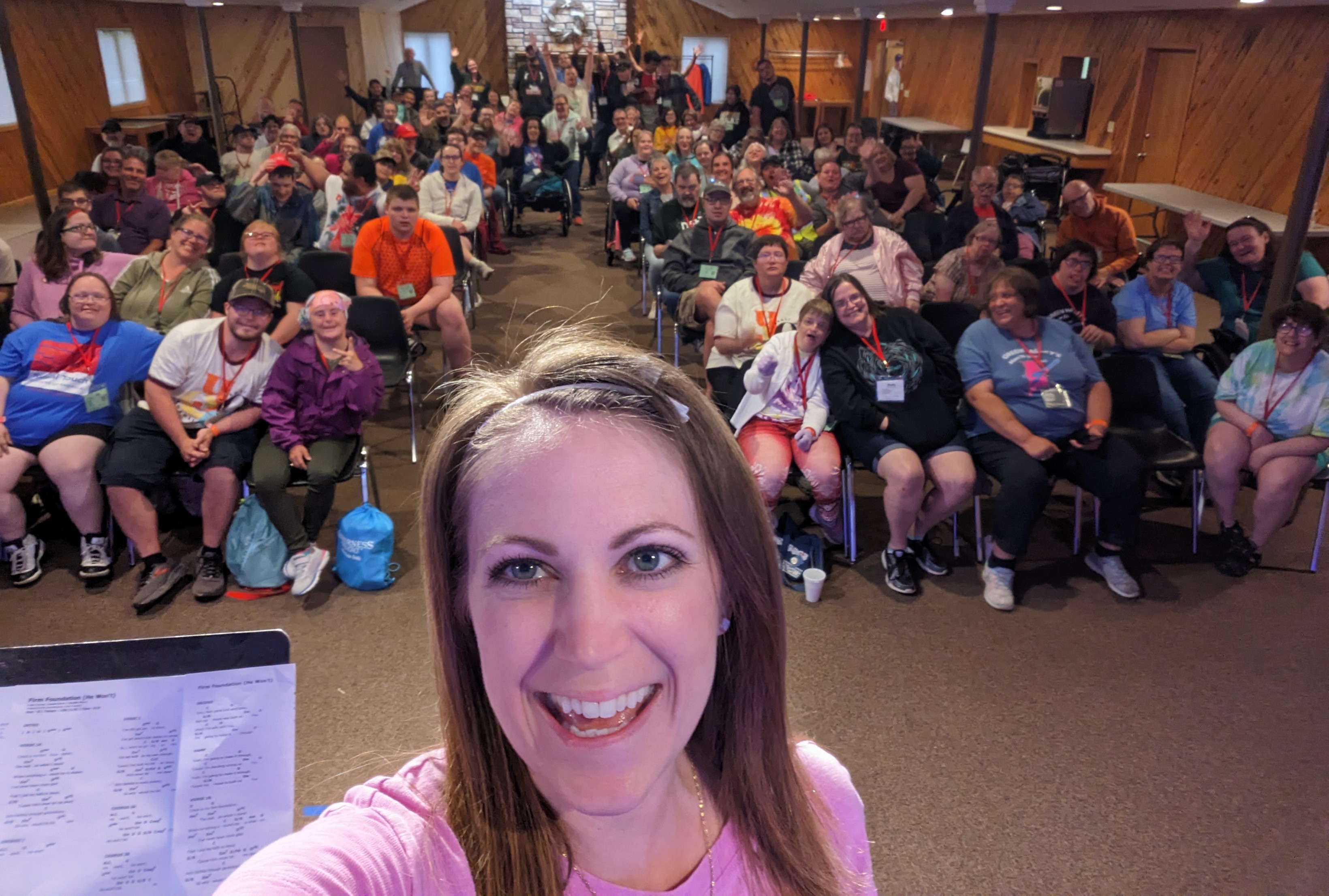 Selfie with a room full of people laughing and cheering