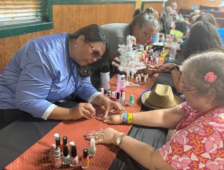A group of women painting the fingernails of other women