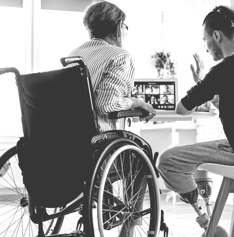 woman and man with clearly visible disabilities meeting with others via online zoom