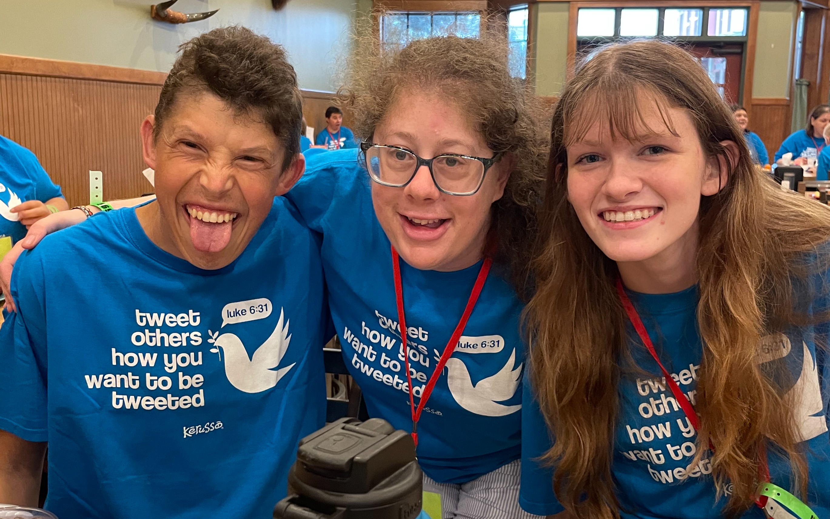 three people having fun with shirts reading tweet how you want to be tweeted