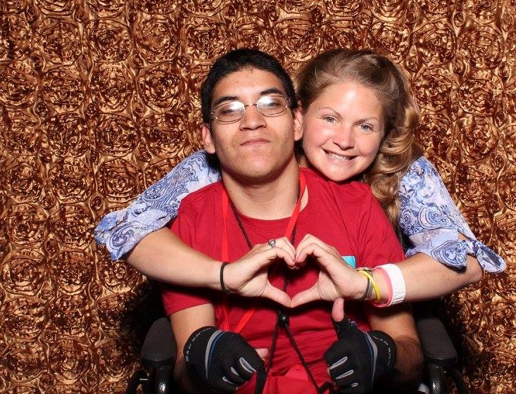 Boy and girl with girl holding hands in shape of a heart