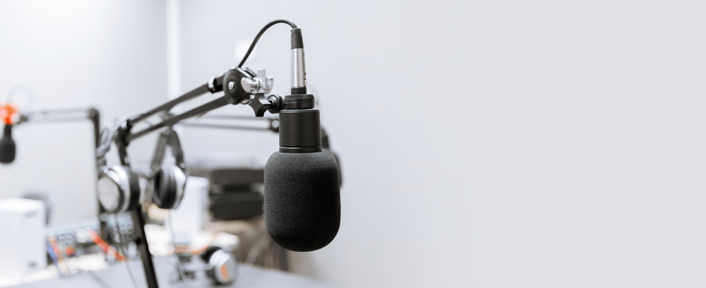 Microphone and headphones on a stand in a room used for recording