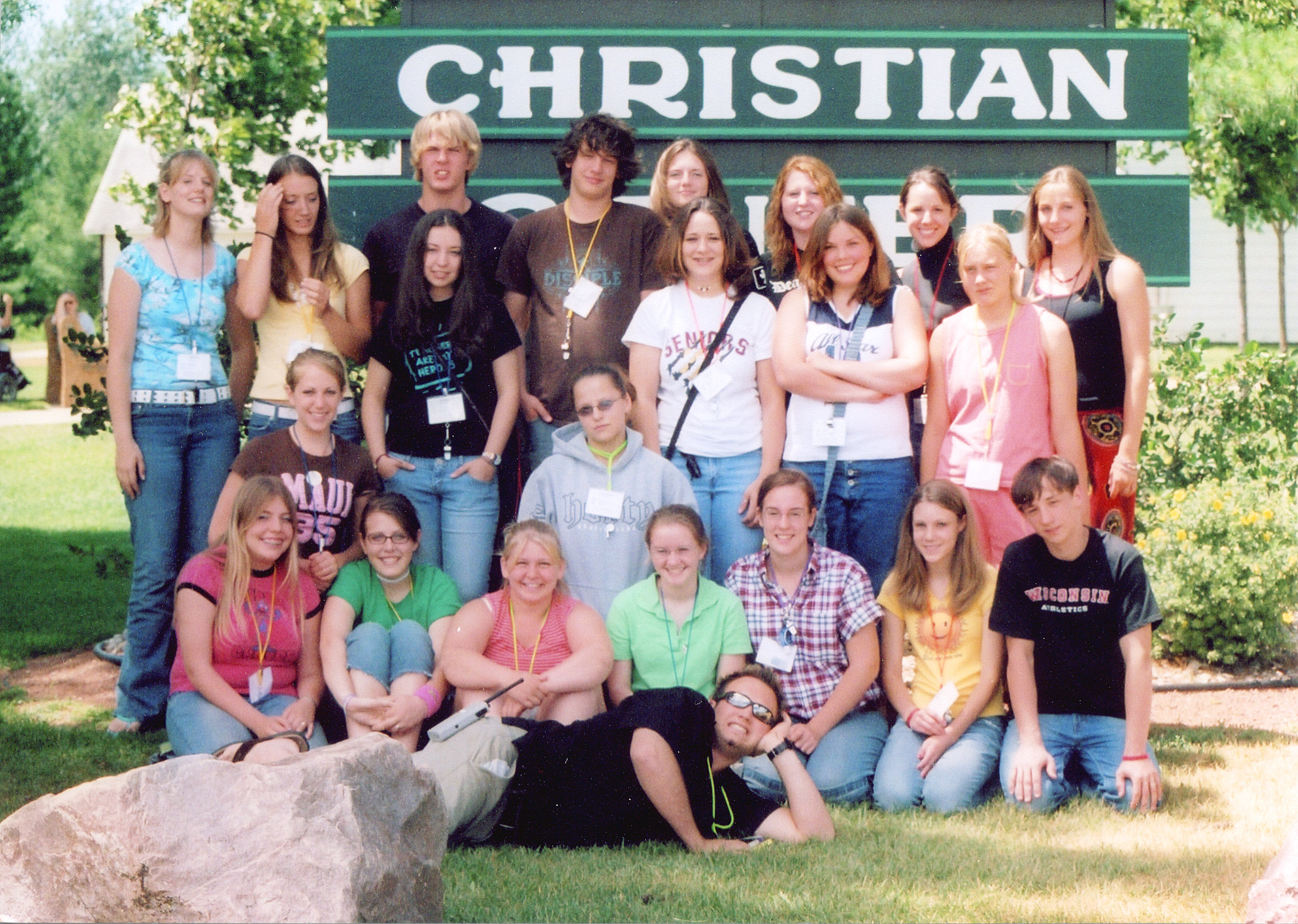 20 CIT youth with one CIT leader in front of sign at camp