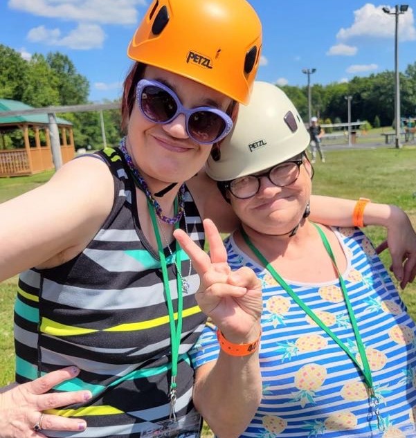 two women with helmets smiling
