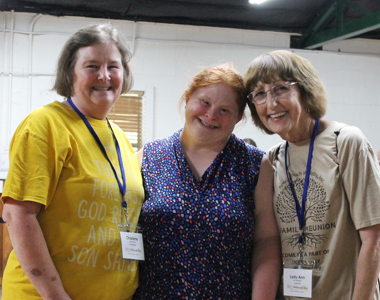 Missionaries Charlene and Ann with a female guest smiling for the picture