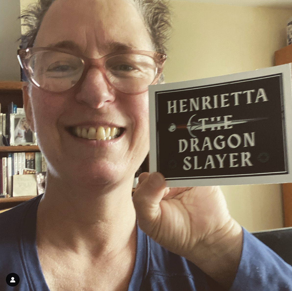 Beth holding up the sticker for the film: Henrietta The Dragon Slayer film A short film of adventure fantasy: magic, friendship and a chimera monster fight. Not a damsel in distress. This heroine saves the day.