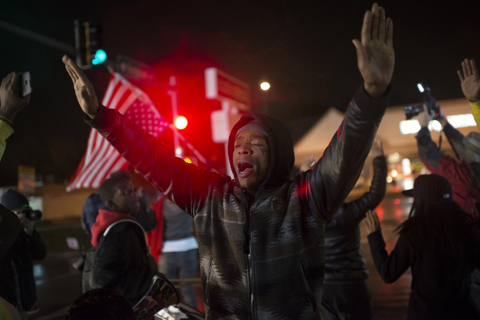 ©Jon Lowenstein / NOOR Caption: USA, Missouri, Ferguson, 2014, The weekend before the Grand Jury verdict residents of the Canfield neighborhood and protestors marched to the memorial where Michael Brown was murdered. There they held a moment of silence and prayed that there would be justice for Mike Brown. On Monday evening it became apparent that there wouldn't be any justice as the Grand Jury decided not to indict Officer Darren Wilson on any charges. Protestors exploded after the verdict and went on to burn 21 buildings as well as do a lot more damage to the town. The protests continue. IG : @jonlowenstein Twitter : @jonlowenstein